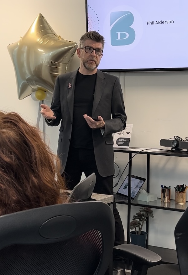 Phil Alderson speaking at a UK breast cancer awareness event